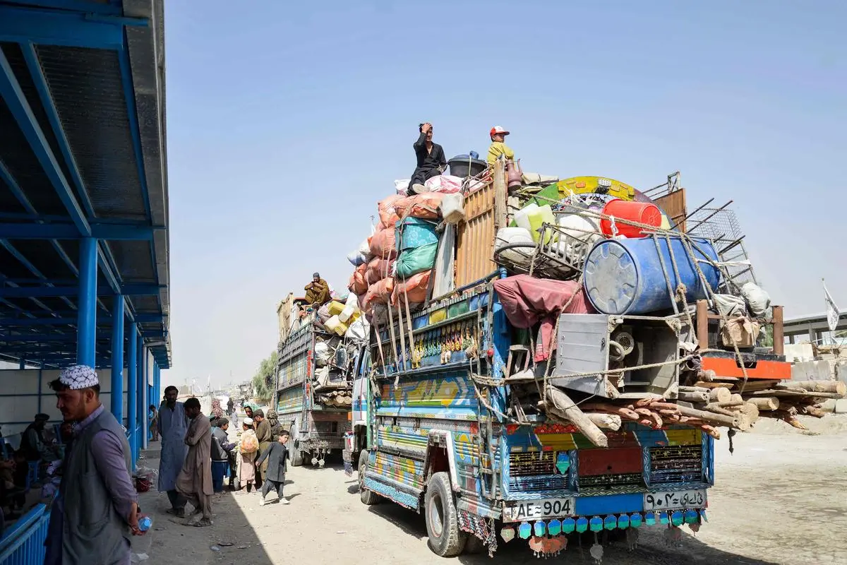 Afghan refugees deported from Pakistan wait inside a registration centre upon their arrival at the zero-point border crossing between Afghanistan and Pakistan in the Spin Boldak district of Kandahar province on October 19, 2025.
