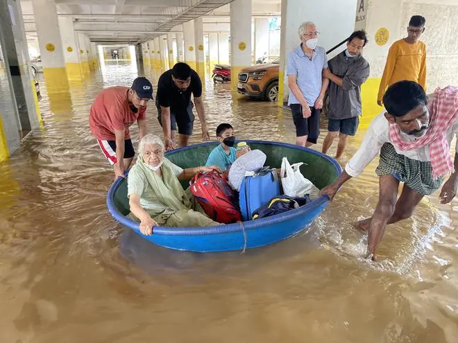 Residents moving out of apartments on Borewell Road in Whitefield on September 7 after the area experienced flooding. Residents moving out of apartments on Borewell Road in Whitefield on September 7 after the area experienced flooding.