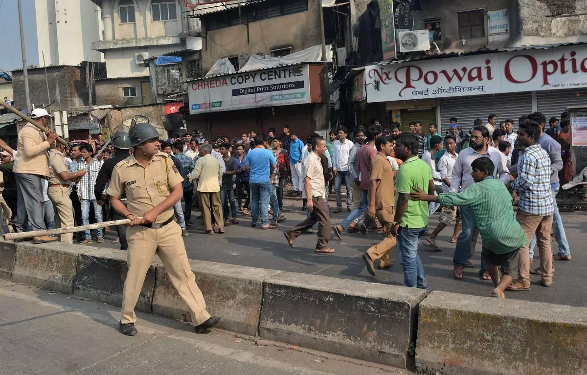 Police personal trying to disrupt the crowd which gathered at IIT Market, Mumbai, during a bandh following the attack at the Bhima Koregaon memorial near Pune on January 3, 2018.