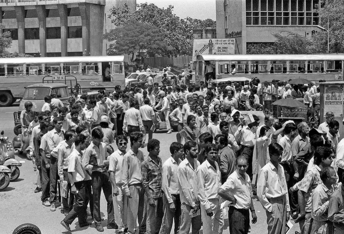 Stock market investors wait in long queues in front of bank counters with share applications at Parliament Street in New Delhi after the Harshad Mehta scam was revealed in 1992.