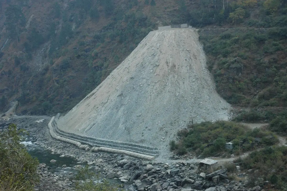 Debris from tunnel construction is dumped into the Bhagirathi river near Dharasu in Uttarkashi.