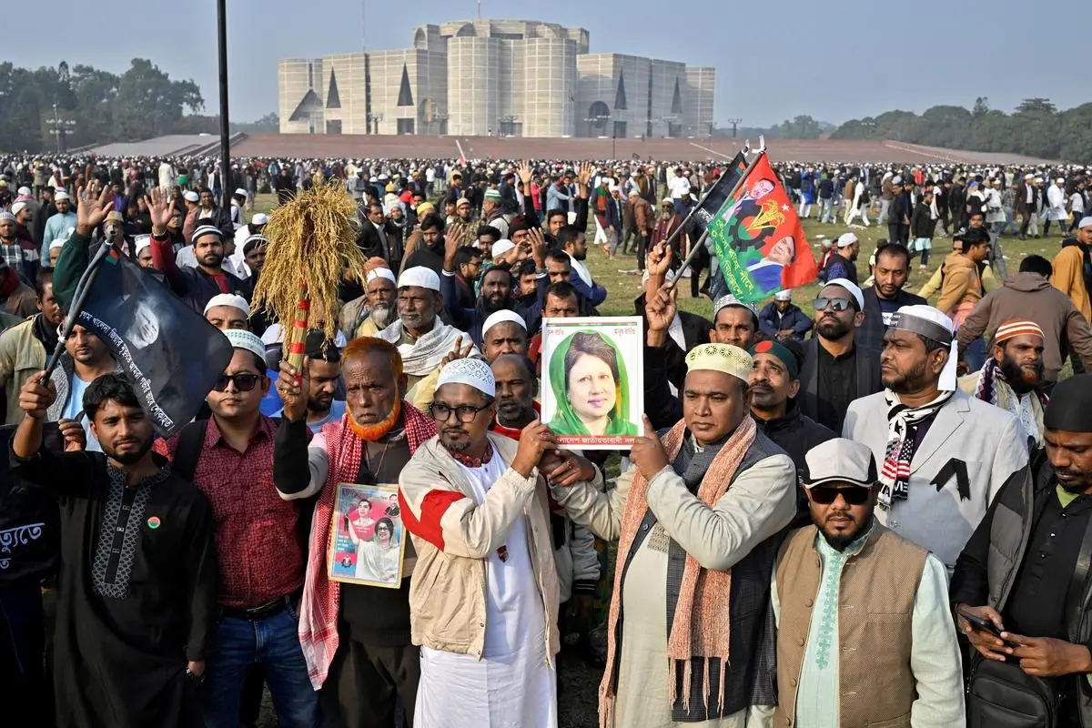 People hold a portrait of Bangladesh's former Prime Minister Khaleda Zia, as they gather to offer funeral prayer for her, at the Parliament building area of Manik Mia Avenue, in Dhaka, Bangladesh, December 31, 2025. 
