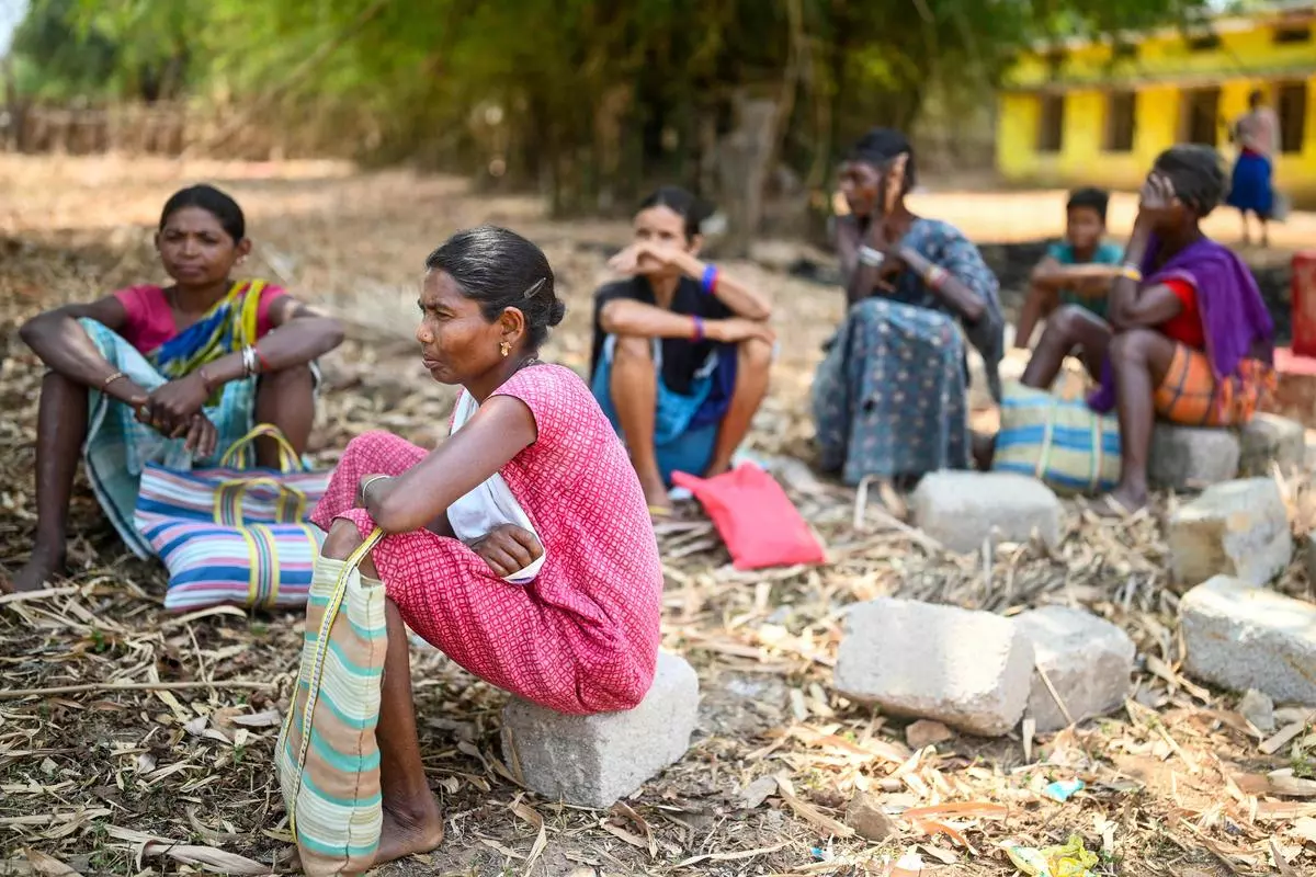 Tribal women waiting outside a ration shop in Tatem village, near Dantewada town in Chhattisgarh, on April 16. The free ration scheme has provided relief to crores of vulnerable people.