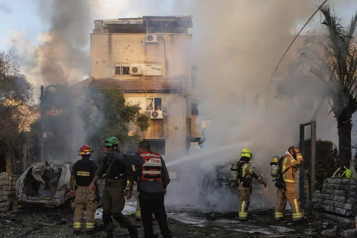 Israeli security and rescue forces at the site of a building hit by a rocket fired from Lebanon, in Kiryat Bialik, northern Israel, on September 22. 