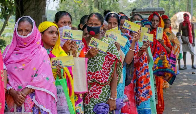 Women wait outside a bank to withdraw cash under the Pradhan Mantri Jan Dhan Yojana, in West Bengal’s Nadia district on May 22, 2020. Women wait outside a bank to withdraw cash under the Pradhan Mantri Jan Dhan Yojana, in West Bengal’s Nadia district on May 22, 2020.