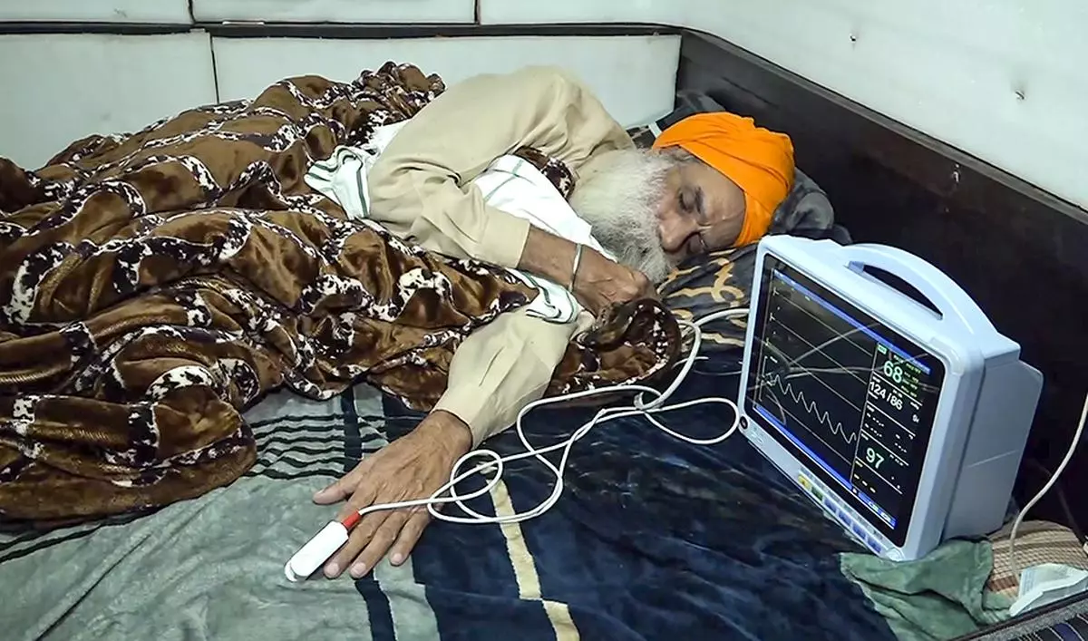 Farmer leader Jagjit Singh Dallewal rests during his hunger strike, at the Khanauri Border in Sangrur district, Monday, December 23, 2024.