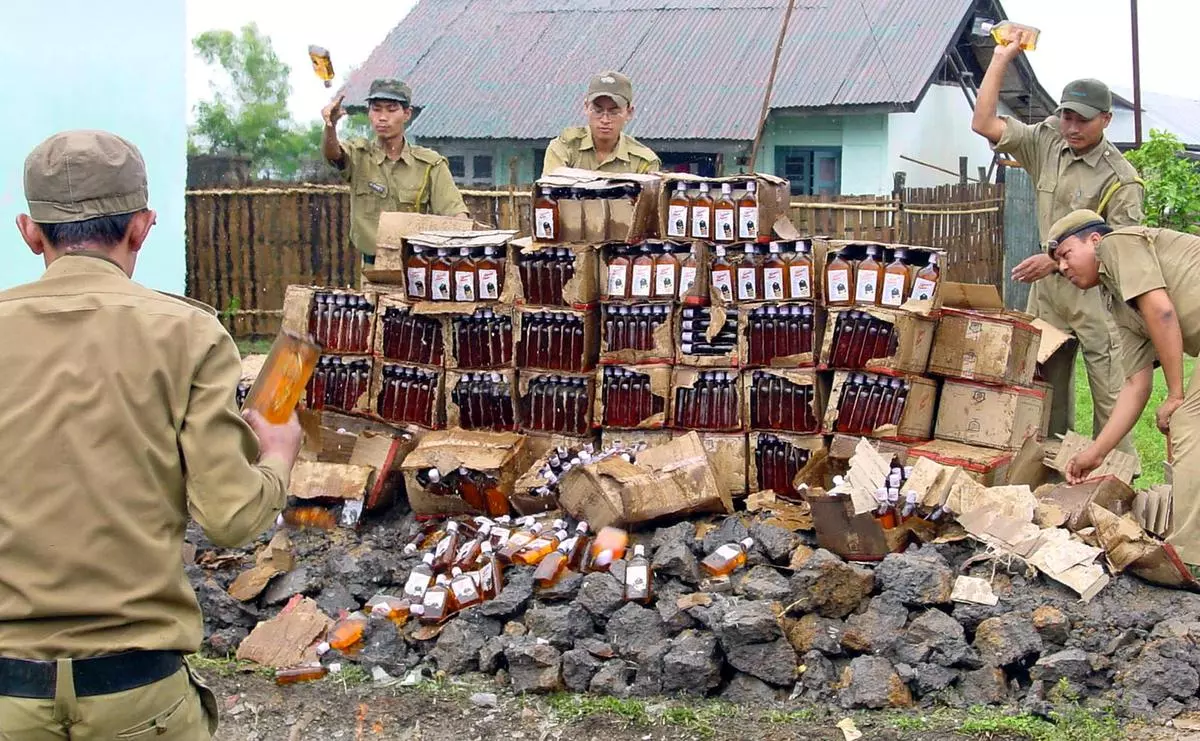 Manipur’s Excise Department officials smash seized liquor and beer bottles in their office premises in lmphal in 2002.