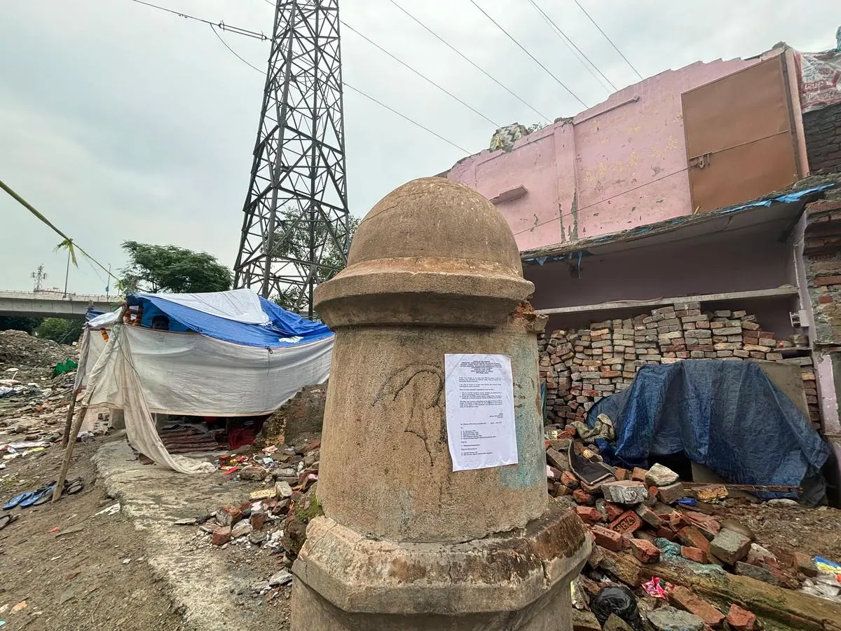 A PWD notice posted on the Barapullah Bridge pillar, next to the demolished remains of a resident’s house. A PWD notice posted on the Barapullah Bridge pillar, next to the demolished remains of a resident’s house.