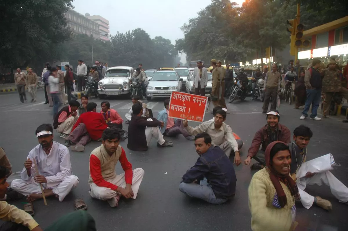 Supporters of the Indian Justice Party block peak-hour traffic on the busy Janpath crossing in Delhi in 2007 as they hold a rally demanding reservation in jobs in the private sector.