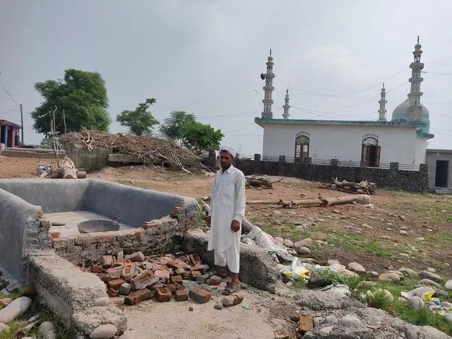 Fareed Choudhary at his village Rajpura camp near the border with Pakistan in Akhnoor sector stands next to a water storage tank that was allegedly destroyed by the authorities in 2021. Fareed Choudhary at his village Rajpura camp near the border with Pakistan in Akhnoor sector stands next to a water storage tank that was allegedly destroyed by the authorities in 2021.