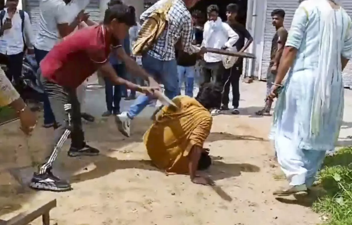 A man being beaten up over suspicion of eating beef, in Charkhi Dadri district in Haryana on August 31.  Five people, who are part of a cow vigilante group, have been arrested for allegedly beating a migrant worker from West Bengal to death. 