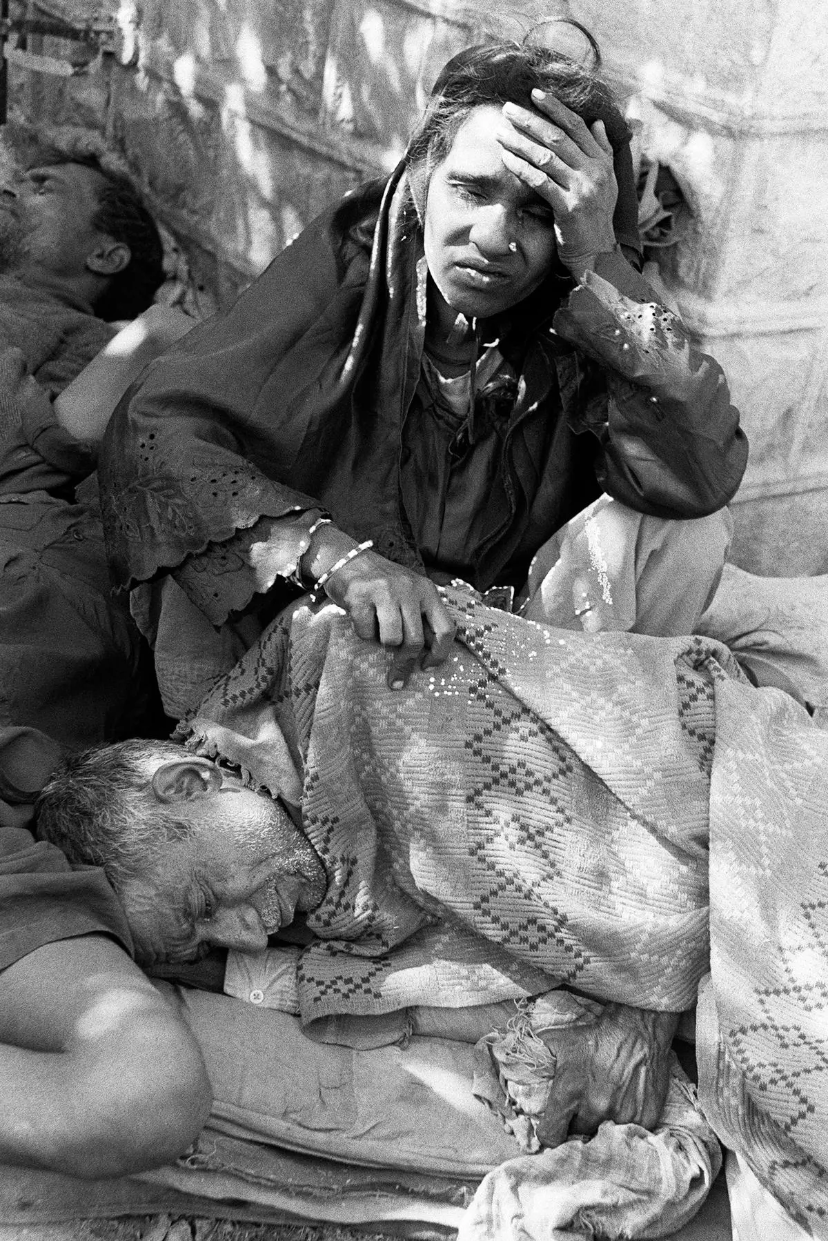 A woman  blinded by the toxic gas that leaked from the Union Carbide factory in Bhopal, waits for care, on December 4, 1984.