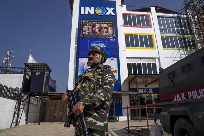 A paramilitary soldier stands guard outside the first multiplex cinema hall of Kashmir in Srinagar on September 30. A paramilitary soldier stands guard outside the first multiplex cinema hall of Kashmir in Srinagar on September 30.