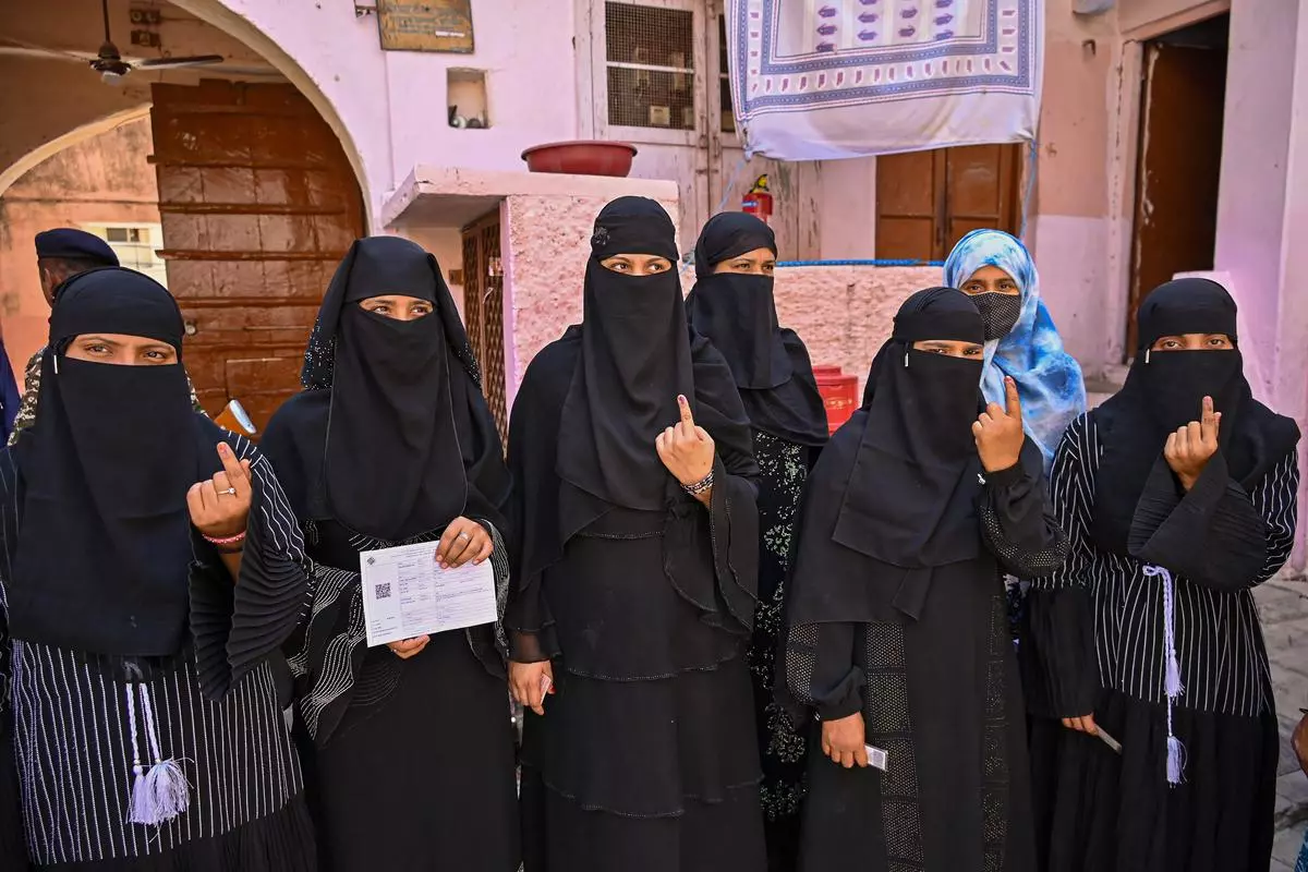 Muslim voters show their ink-marked fingers after casting their votes for the second phase of Lok Sabha elections, in Ajmer, on April 26, 2024.