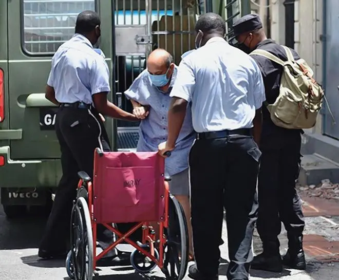 Mehul Choksi is assisted by the police into a wheelchair as he arrives at the magistrate’s court in Roseau, Dominica, on June 4, 2021. Mehul Choksi is assisted by the police into a wheelchair as he arrives at the magistrate’s court in Roseau, Dominica, on June 4, 2021.
