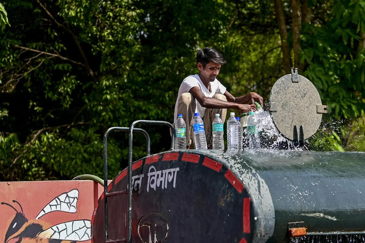 A man filling water bottles on top of a water tanker, in Prayagraj, Uttar Pradesh, on April 17, 2026. By 2030, NITI Aayog estimates that demand for water will be double the available supply.