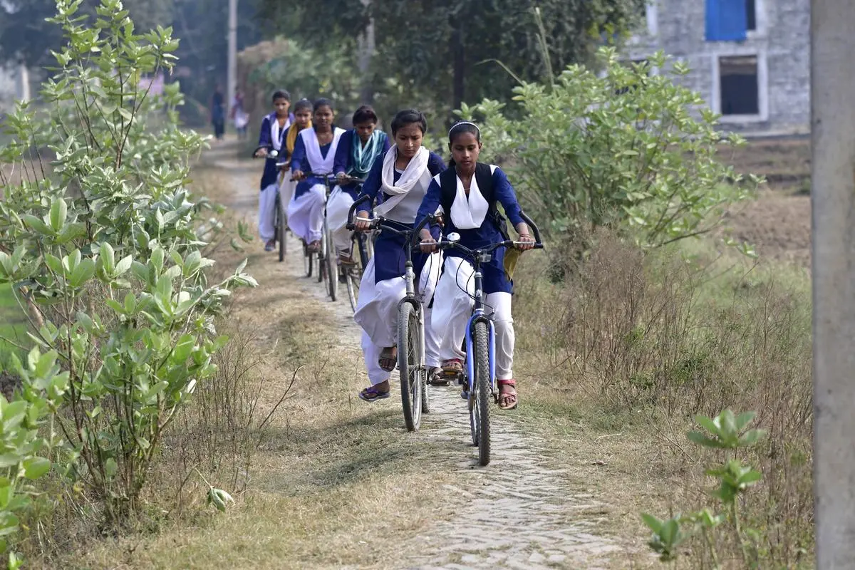 In 2007, Nitish Kumar launched the Mukhyamantri Balika Cycle Yojana providing free bicycles to every girl child in class IX to prevent them from dropping out of school after a certain age. In the picture, beneficiaries of the scheme on the outskirts of Patna in 2018. 