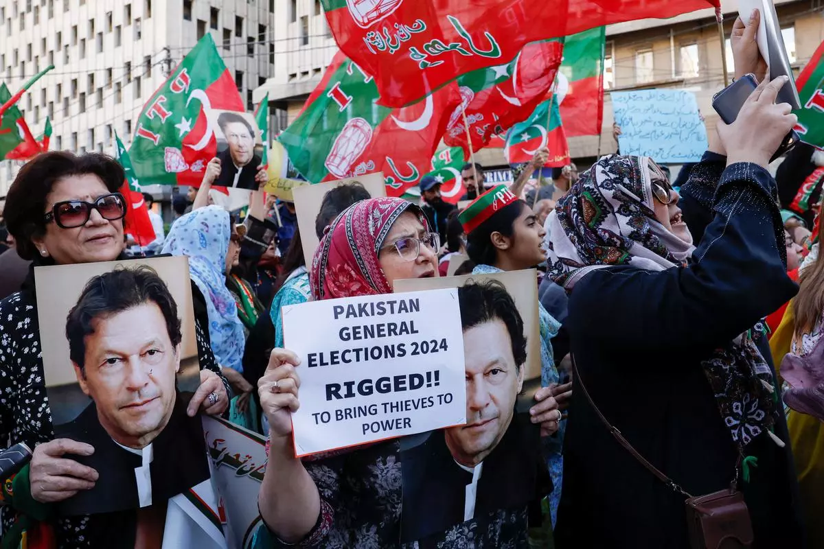 Supporters of Pakistan Tehreek-e-Insaf (PTI) carry posters and placards as they chant slogans against what they call, ‘blatant rigging in national election’, during a protest in Karachi on March 2, 2024. 