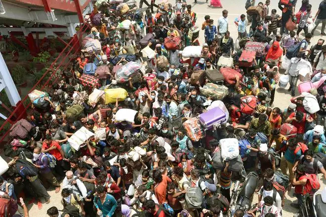 Migrants who arrived by Shramik special trains scramble to board a local train at Danapur Railway Station in Patna on May 24, 2020. Migrants who arrived by Shramik special trains scramble to board a local train at Danapur Railway Station in Patna on May 24, 2020.