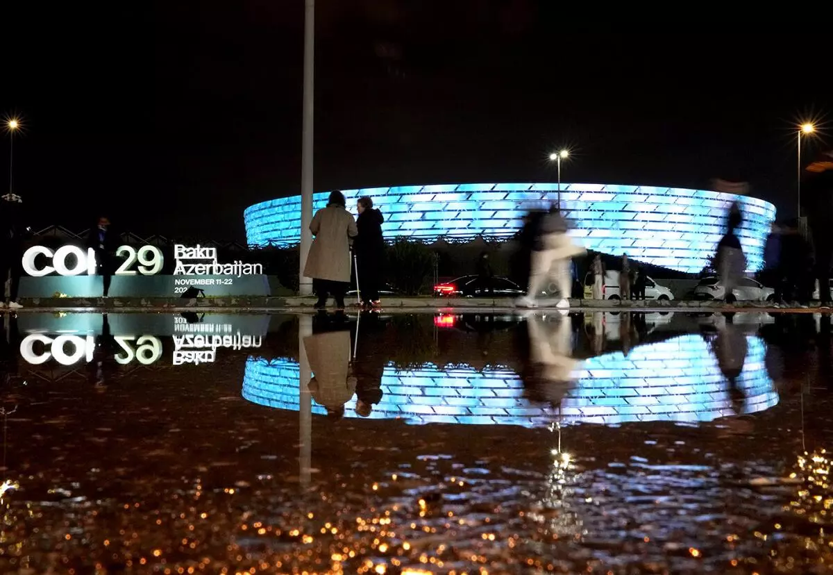 People walk in front of the Baku Olympic Stadium, the venue for the COP29 U.N. Climate Summit on November 18, 2024, in Baku, Azerbaijan. Climate finance proved to be the main issue during this year’s COP. 