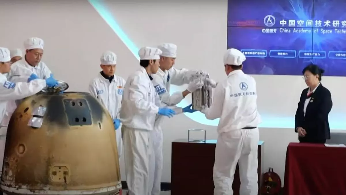 Technicians remove the samples collected on the moon’s far side from the return capsule of the Chang’e-6 lunar mission.