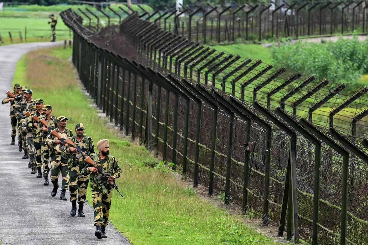 BSF personnel patrol along the borderline fence at the India-Bangladesh border in Golakganj, Dhubri district, on May 26. BSF personnel patrol along the borderline fence at the India-Bangladesh border in Golakganj, Dhubri district, on May 26.