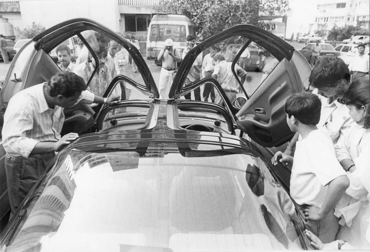 Potential buyers examine a Toyota Sera belonging to Harshad Mehta at his residence in Mumbai. The 18 cars Mehta owned were auctioned by a Special Court.