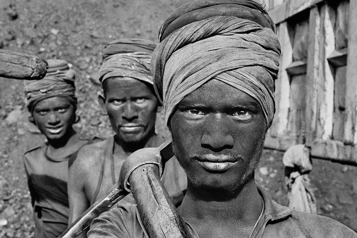 “Workers emerging from a coal mine. Dhanbad, Bihar State, India,” (1989) by Sebastião Salgado.