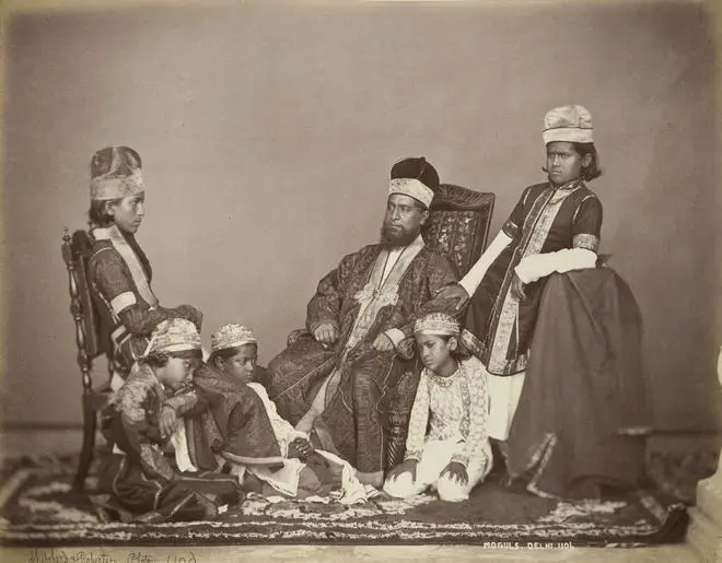 Studio portrait of a Mogul father with his children in Delhi, c. 1860s. Studio portrait of a Mogul father with his children in Delhi, c. 1860s.