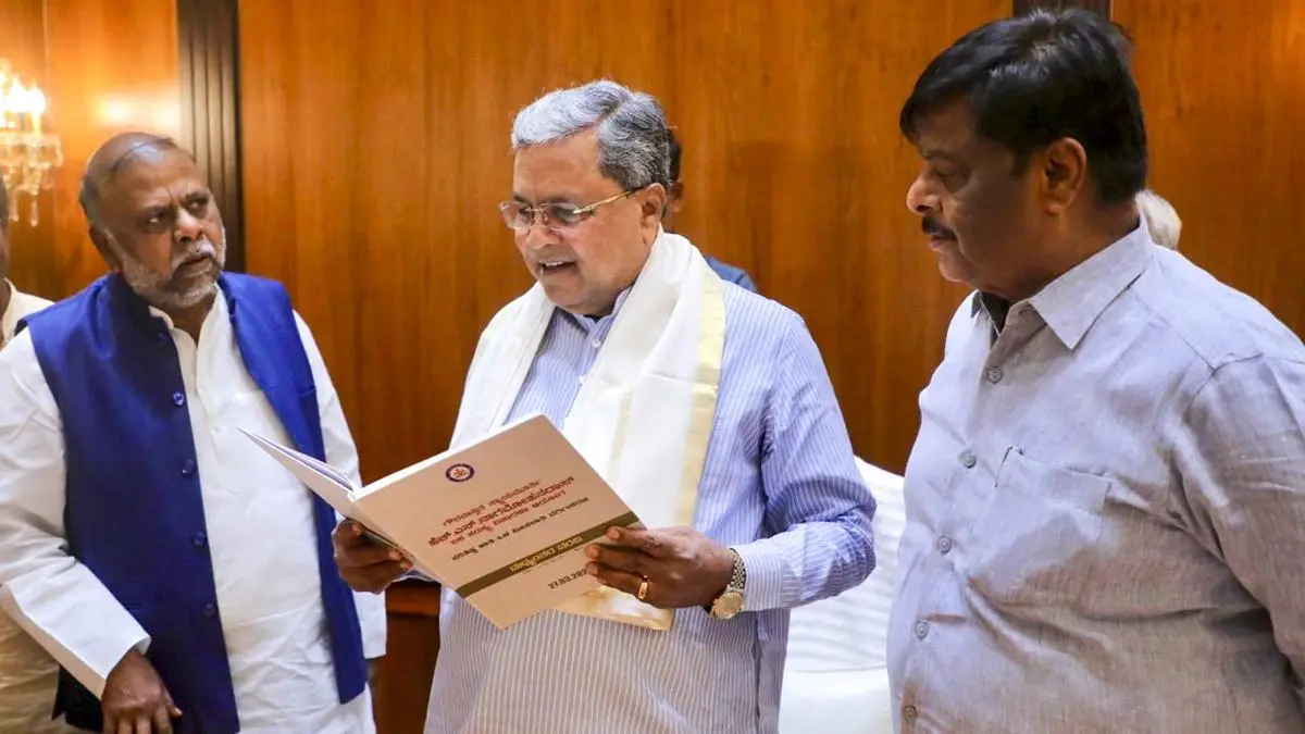 Karnataka Chief Minister Siddaramaiah receives the interim report of the committee headed by retired Justice Nagamohan Das, which was formed to provide internal reservation for Dalit communities, in Bengaluru.