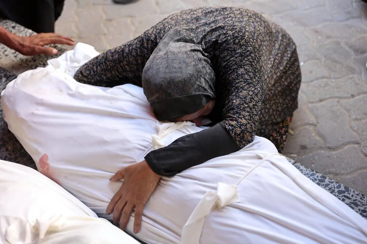 A woman mourns over the shrouded body of a Palestinian killed during a reported Israeli strike on a humanitarian aid distribution warehouse in the Sabra neighbourhood in Gaza City, on June 30, 2025. A woman mourns over the shrouded body of a Palestinian killed during a reported Israeli strike on a humanitarian aid distribution warehouse in the Sabra neighbourhood in Gaza City, on June 30, 2025.