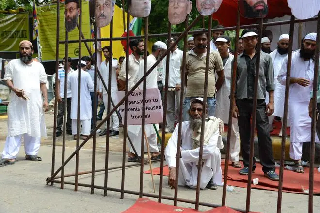 Members of Popular Front of India, a confederation of Muslim organisations, sit inside a mock prison during a protest rally demanding release on bail of undertrial prisoners from Muslim, tribal and other minority communities, in New Delhi on September 15, 2012. Members of Popular Front of India, a confederation of Muslim organisations, sit inside a mock prison during a protest rally demanding release on bail of undertrial prisoners from Muslim, tribal and other minority communities, in New Delhi on September 15, 2012.