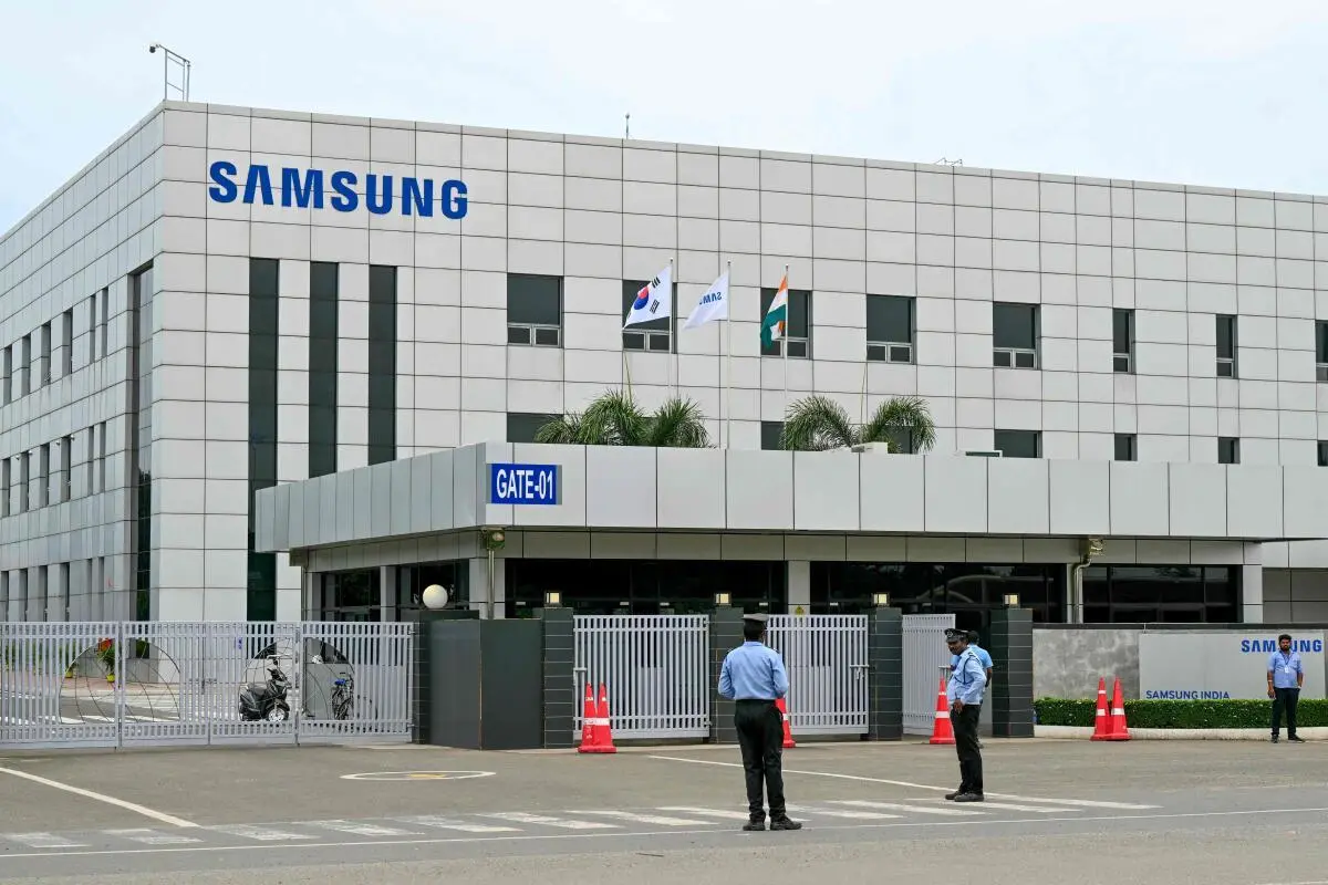 Security personnel stand guard at Samsung India’s plant in Sriperumbudur on September 11, 2024, as workers stage protests to demand higher wages, better working conditions, and recognition of their union. 