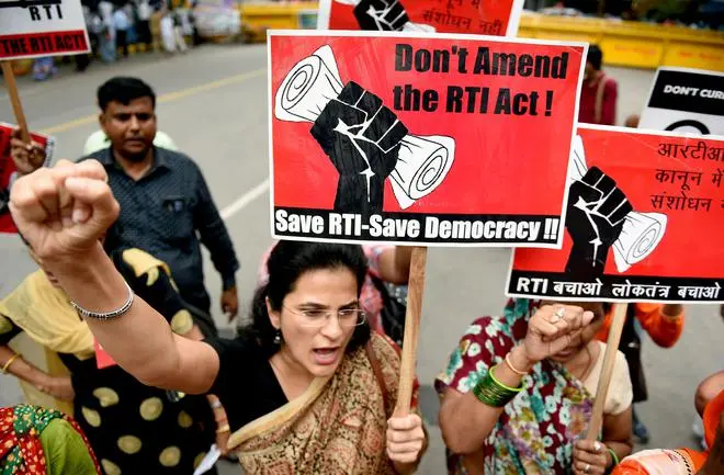 Activists shout slogans during a protest against the amendments to the RTI Act in New Delhi in 2019. Activists shout slogans during a protest against the amendments to the RTI Act in New Delhi in 2019.