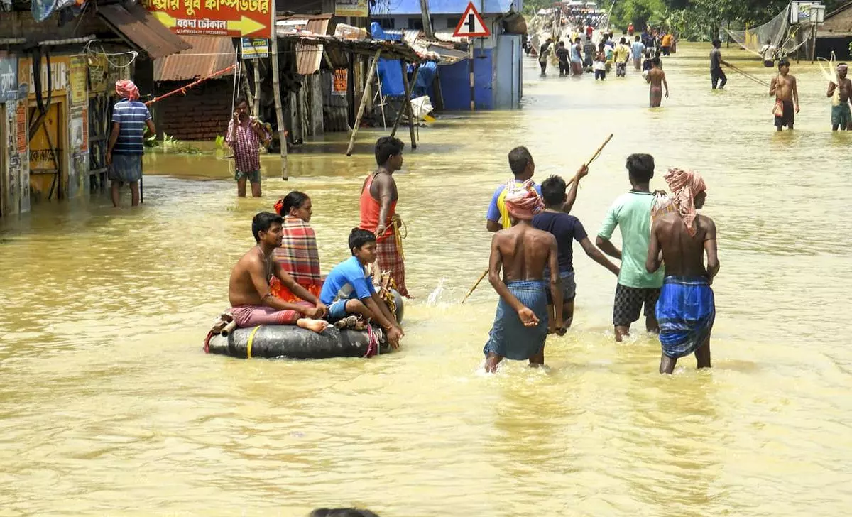 People wading to safety In Paschim Medinipur district on September 20. 