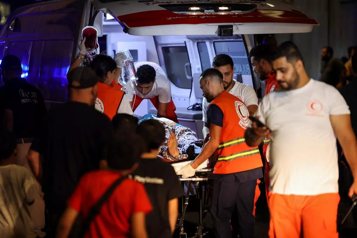 A person is carried on a stretcher outside the American University of Beirut Medical Center after the explosions. Beirut, Lebanon, September 17, 2024. 