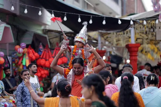 Dancing to the drumbeat on papa’s shoulders. It is mainly boys, from infants to teenagers, and in some cases a few years older as well, who dress up as Langurs for the festival. Dancing to the drumbeat on papa’s shoulders. It is mainly boys, from infants to teenagers, and in some cases a few years older as well, who dress up as Langurs for the festival.