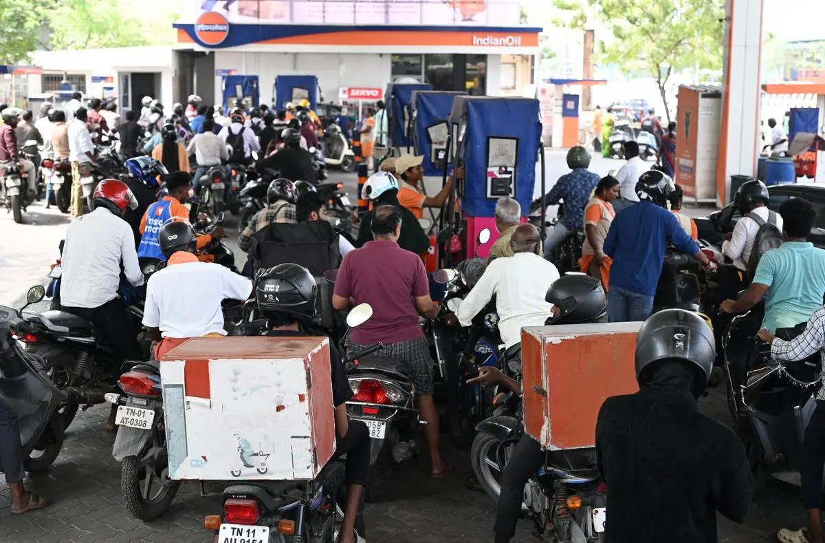 People queue up to refuel their vehicles at an Indian Oil fuel station, in Chennai, on March 12.