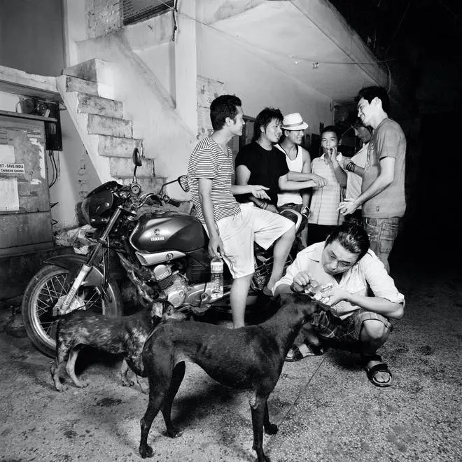 Thar, Serena Chopra’s first assistant, with a dog in the temple square. A group of Tibetan youths hang out in the background. A 2008 photograph. Thar, Serena Chopra’s first assistant, with a dog in the temple square. A group of Tibetan youths hang out in the background. A 2008 photograph.