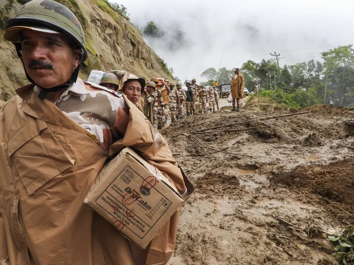 Indo-Tibetan Border Police personnel trek through tough terrain to deliver food supplies to stranded civilians at Tachor Potu, NH-13, Arunachal Pradesh, on June 2. Indo-Tibetan Border Police personnel trek through tough terrain to deliver food supplies to stranded civilians at Tachor Potu, NH-13, Arunachal Pradesh, on June 2.