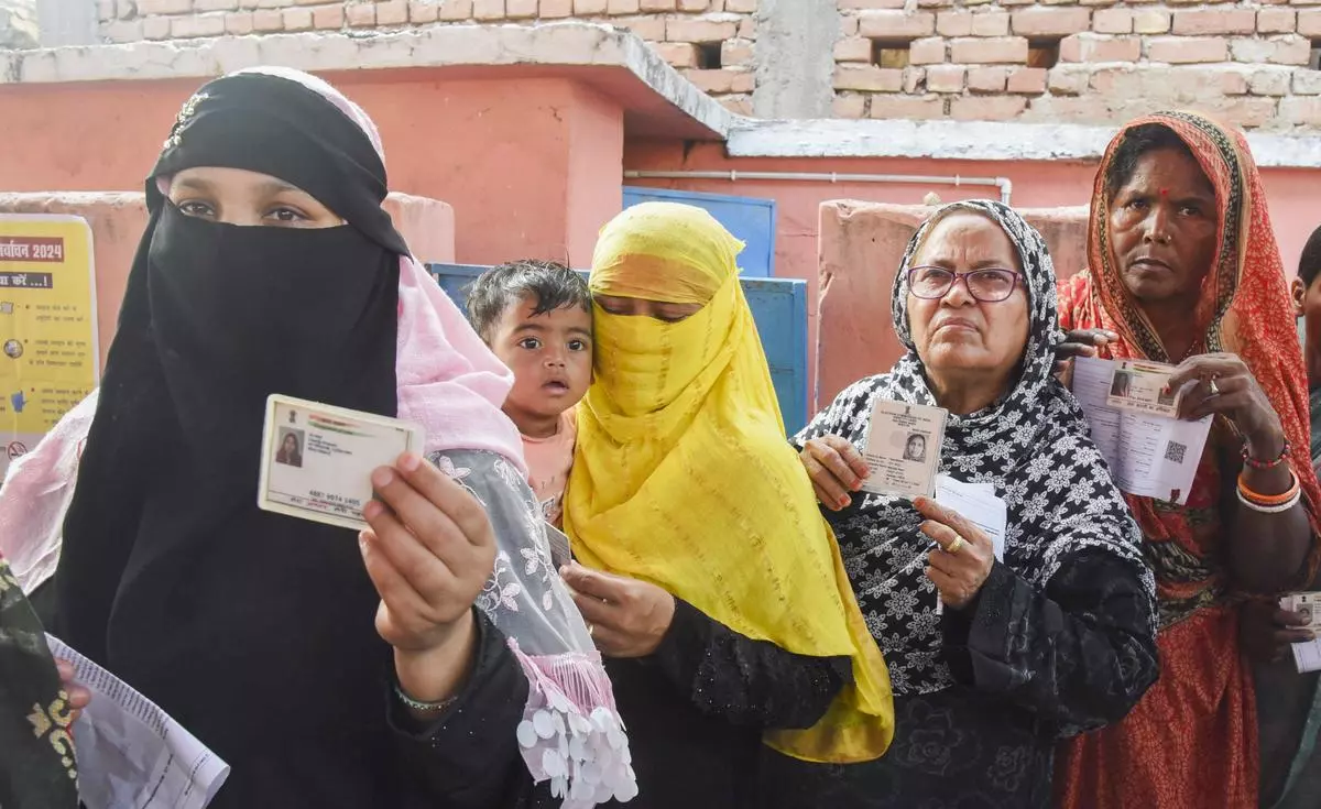 Women voters show their identity cards as they wait in a queue to cast their votes during the sixth phase of the Lok Sabha election, in Vaishali district, Bihar, on May 25. Women voters show their identity cards as they wait in a queue to cast their votes during the sixth phase of the Lok Sabha election, in Vaishali district, Bihar, on May 25.