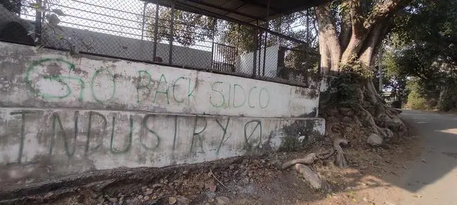 A wall graffiti reading “SIDCO go back” at Kathua district’s Barwal village. A wall graffiti reading “SIDCO go back” at Kathua district’s Barwal village.
