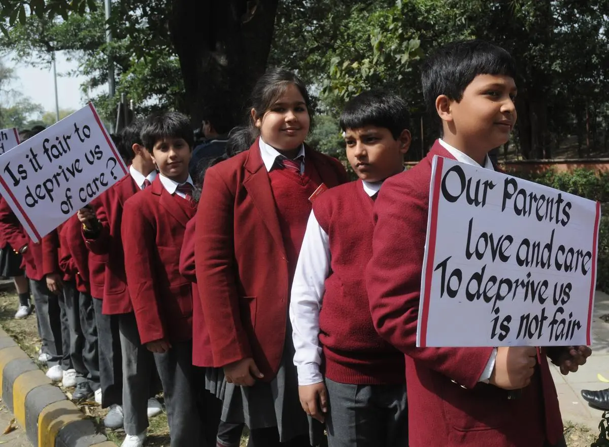 Schoolchildren participate in a protest led by the parents of Sagarika Chakraborty in New Delhi on February 27, 2012.