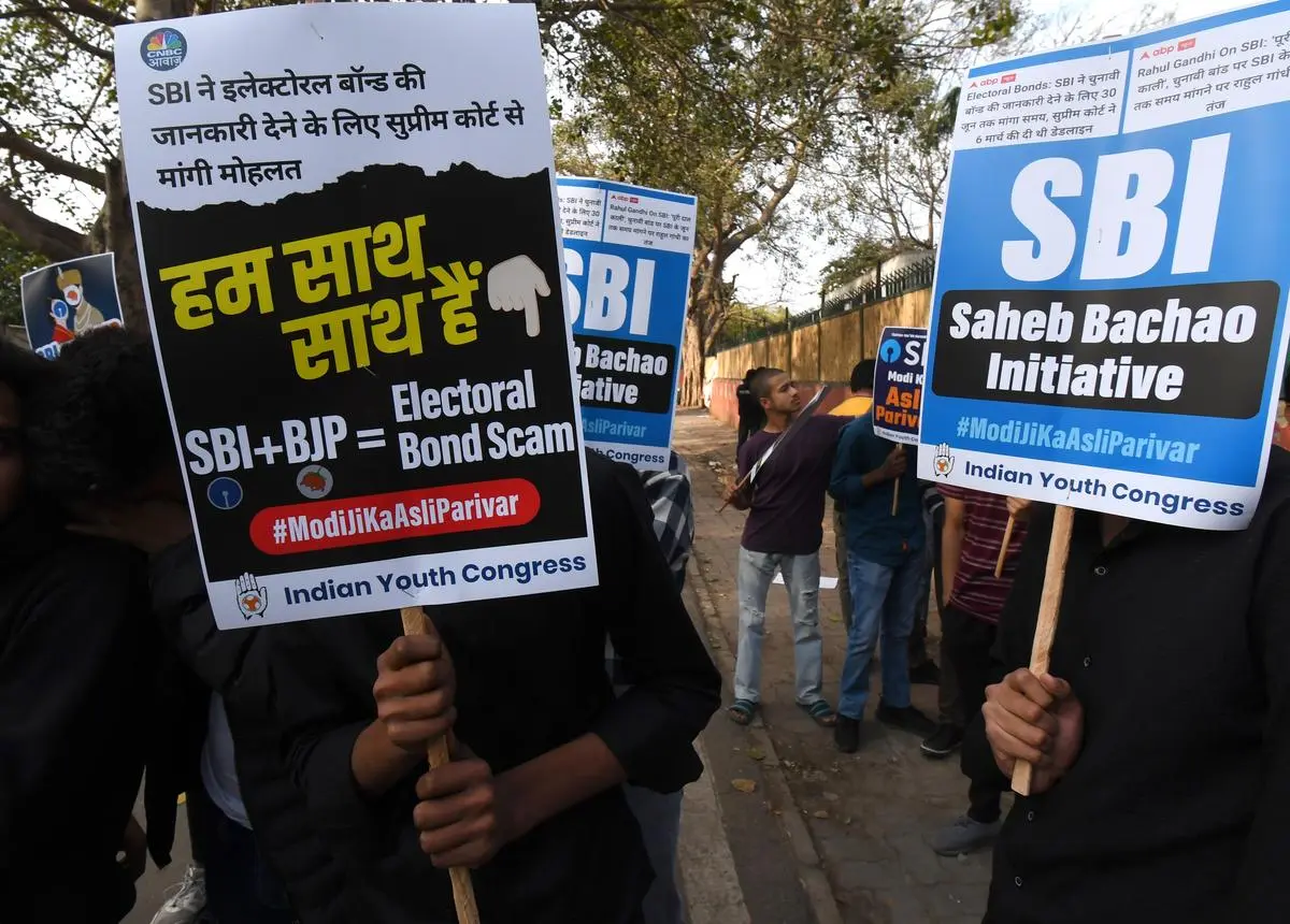 Members and supporters of Indian Youth Congress stage a protest demanding SBI to reveal the names of electoral bond donors in New Delhi on March 5.