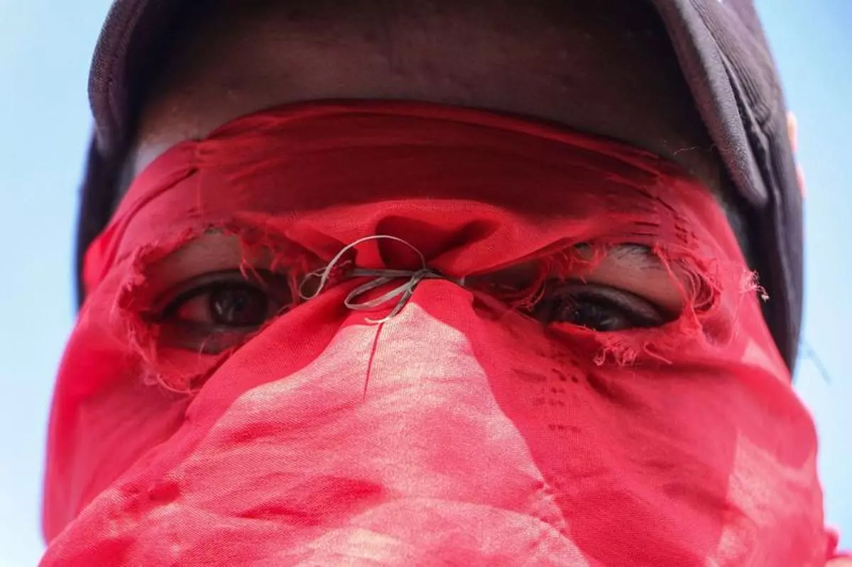 A young boy, his face adorned with a party flag, attends a rally in Tangmarg, Baramulla district, Jammu and Kashmir, on September 28, 2024