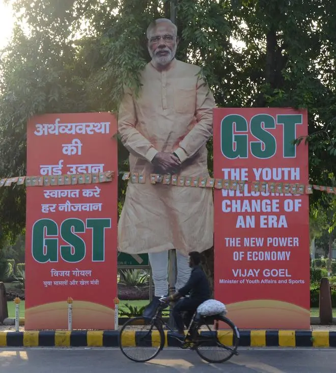 A billboard displaying an image of Prime Minister Narendra Modi and announcing the implementation of the GST. Modi promised the citizen in 2017 that she would be liberated from the menace of “tax terrorism”.