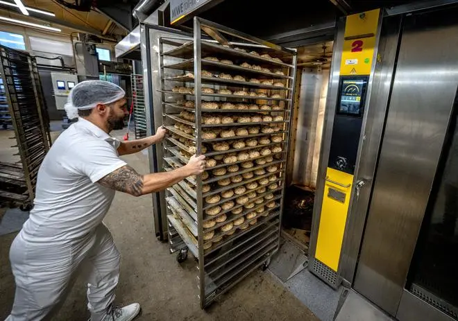An employee at a bakery in Neu Isenburg, Germany, pushes rolls into a gas-heated oven, on September 19. As winter approaches, some small bakeries in the country are contemplating shutting down due to the energy crisis. An employee at a bakery in Neu Isenburg, Germany, pushes rolls into a gas-heated oven, on September 19. As winter approaches, some small bakeries in the country are contemplating shutting down due to the energy crisis.