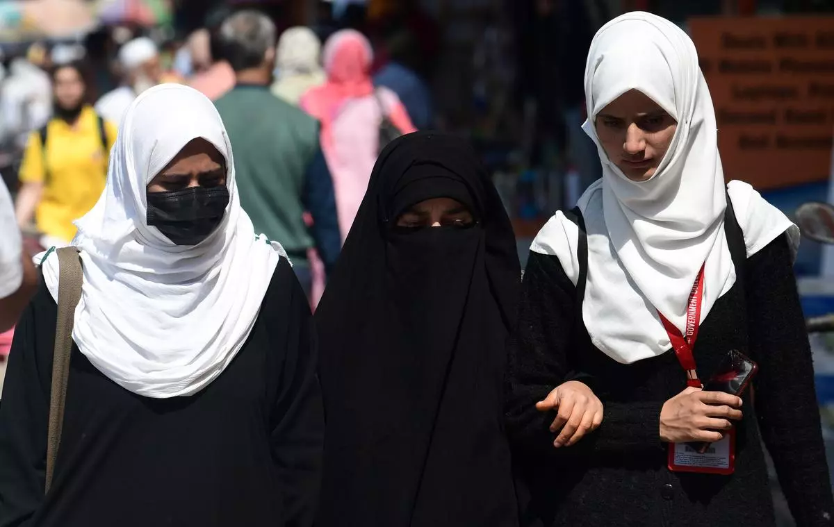 College students walk though a market Srinagar on April 27, 2022. Photo for representation. 