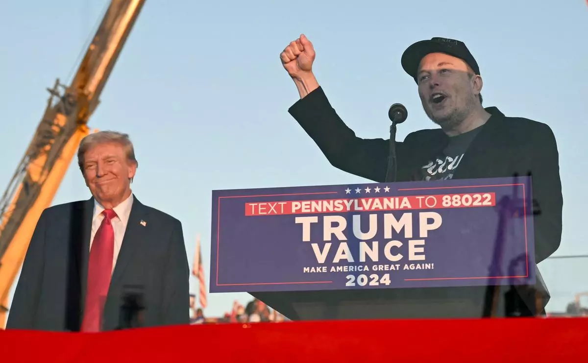 Elon Musk, CEO of Tesla, with United States President-elect Donald Trump during a campaign rally in Butler, Pennsylvania, United States, October 5, 2024. Elon Musk, the most the world's wealthiest, is positioned to hold sweeping powers in the second Trump administration as a deputy tasked with restructuring government operations using his aggressive approach to business.