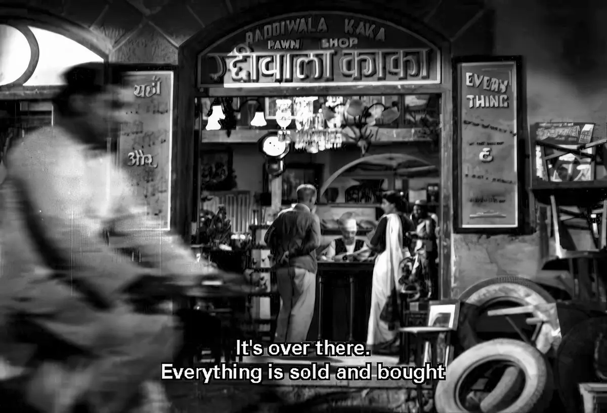 The pawnbroker’s shop, where Raj sells his “honesty” medal for Rs.40.